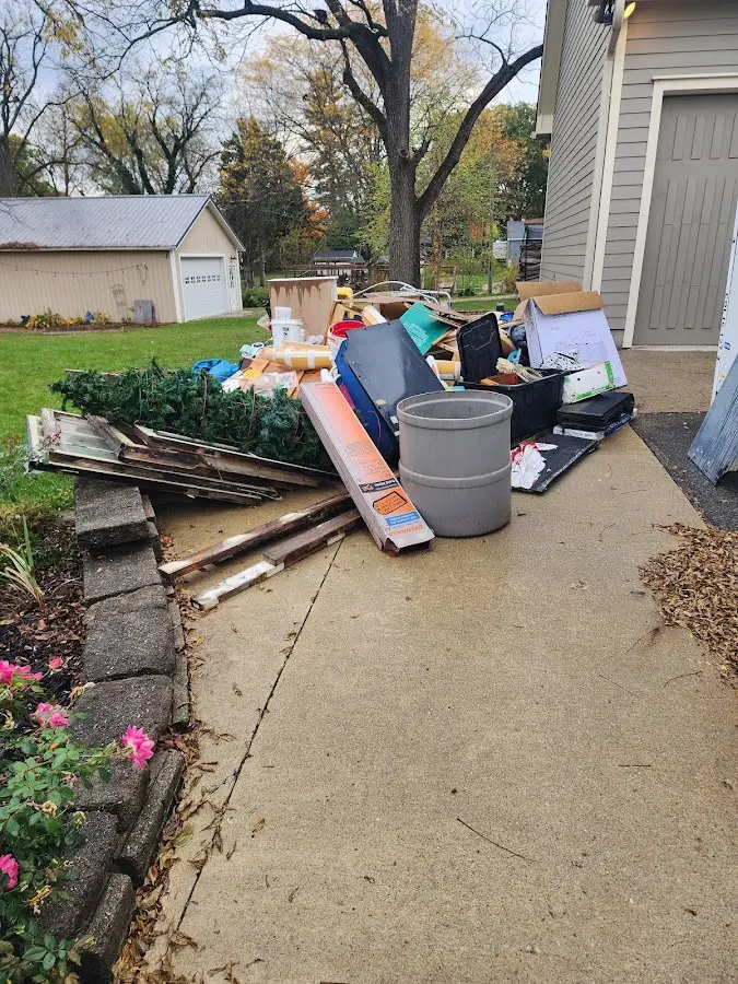 Dumpster being loaded with debris for 30 Yard Dumpster Rental in Clinton